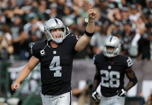 Oakland Raiders quarterback Derek Carr (4) reacts after throwing a touchdown pass to wide receiver Michael Crabtree during the first half of an NFL football game against the New York Jets in Oakland, Calif., Sunday, Nov. 1, 2015. (AP Photo/Marcio Jose Sanchez)
